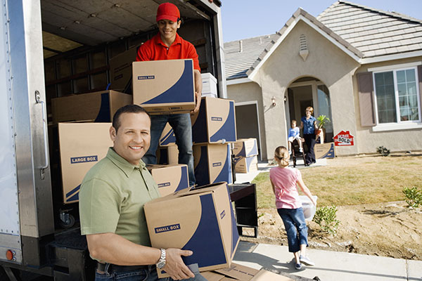 Family with the moving service worker unloads boxes for new house